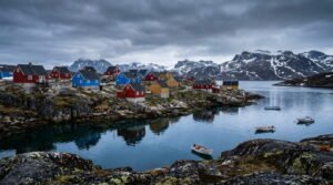 Colorful Greenlandic town with painted wooden houses on fjord showing local community for Greenland travel tips